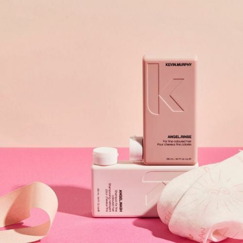 KEVIN.MURPHY ANGEL.RINSE and ANGEL.WASH bottles on a pink background
