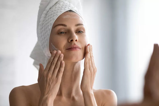 Woman applying moisturiser as part of a simple skincare routine
